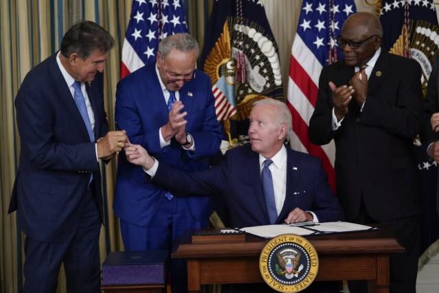 president-biden-inks-inflation-act-hands-pen-to-manchin